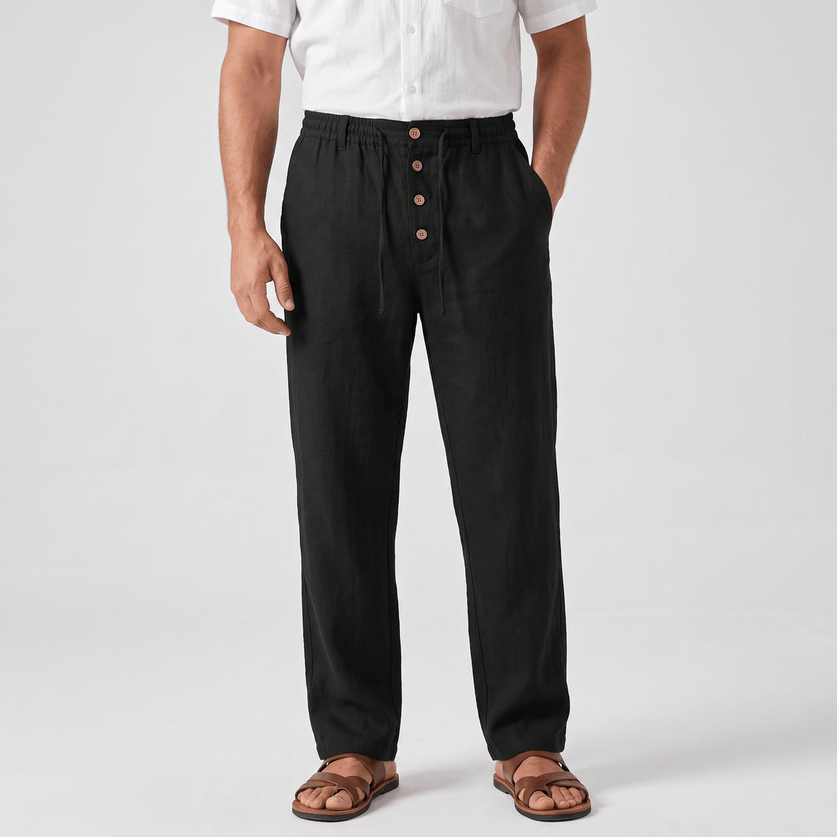 Men's black linen drawstring pants with a relaxed straight-leg fit, elastic waistband, and side pockets.