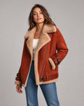 Brown shearling aviator jacket for women worn by a model, featuring plush lining and wide collar