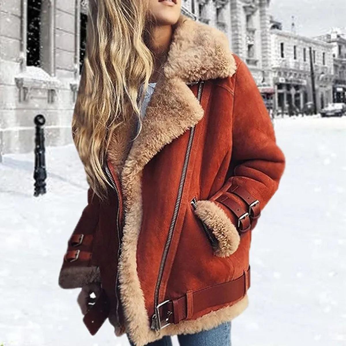 Brown shearling aviator jacket for women worn by a model, featuring plush lining and wide collar