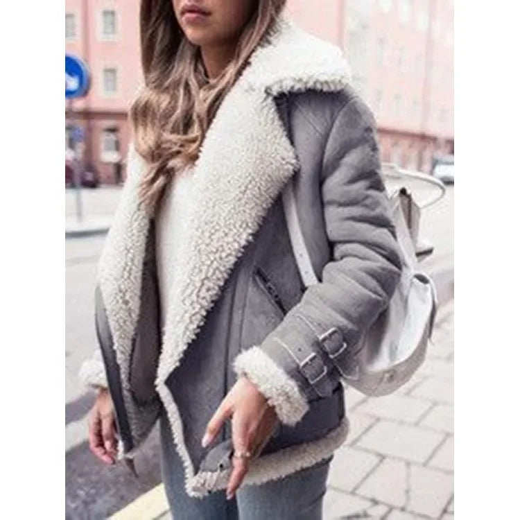 Gray shearling aviator jacket for women worn by a model, featuring plush lining and wide collar