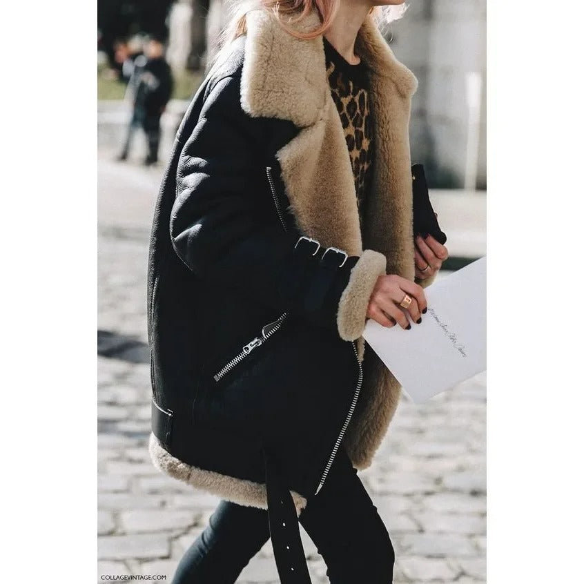 Black shearling aviator jacket for women worn outdoors, featuring plush lining and wide collar