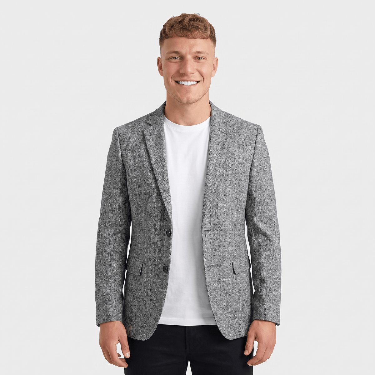 Man wearing a light gray tweed blazer over a white dress shirt with a tailored fit and classic notched lapel.