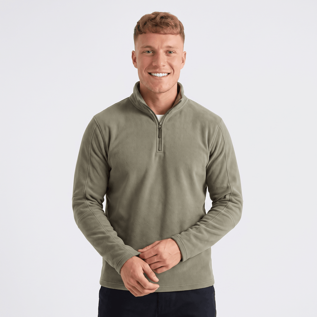 Man wearing an olive green quarter-zip knit sweater with a stand collar, long sleeves, and a modern classic fit.
