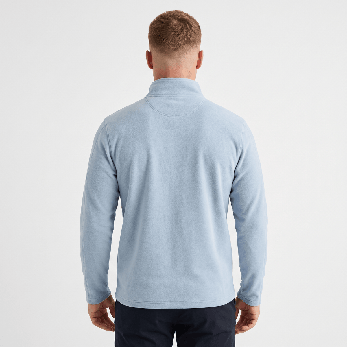 Back view of a men's light blue quarter-zip knit sweater with a stand collar and ribbed cuffs.