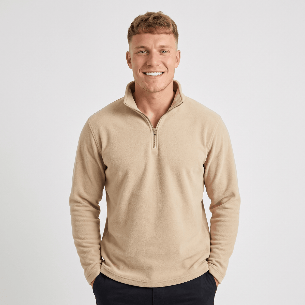 Man wearing a beige quarter-zip knit sweater with a stand collar, long sleeves, and a relaxed fit.
