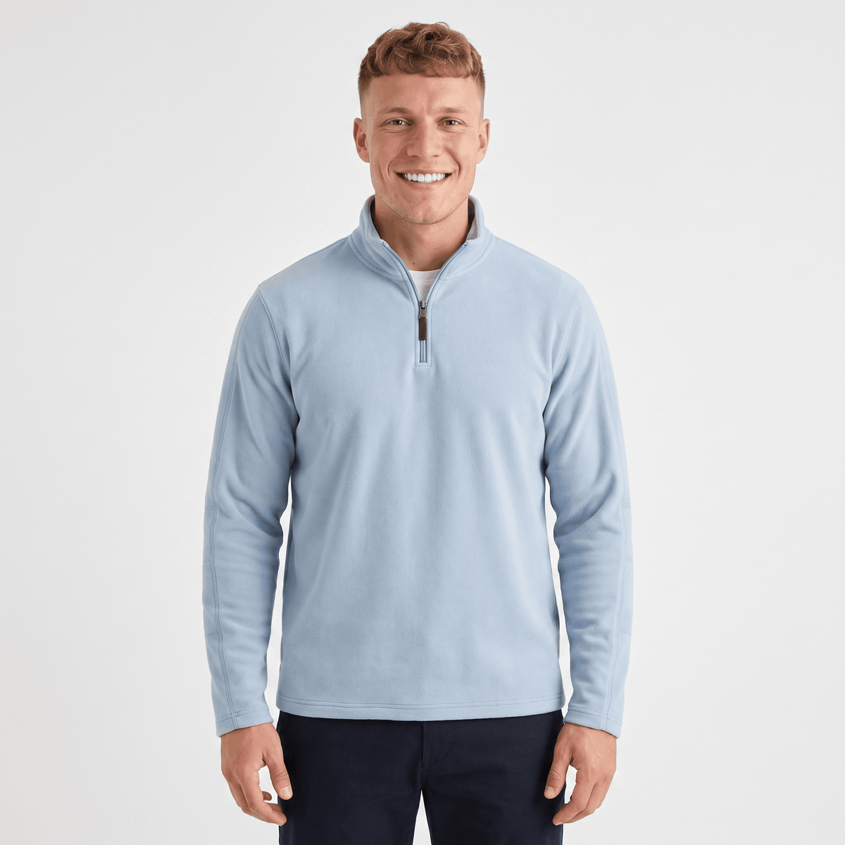 Man wearing a light blue quarter-zip knit sweater with a stand collar, long sleeves, and a classic fit.