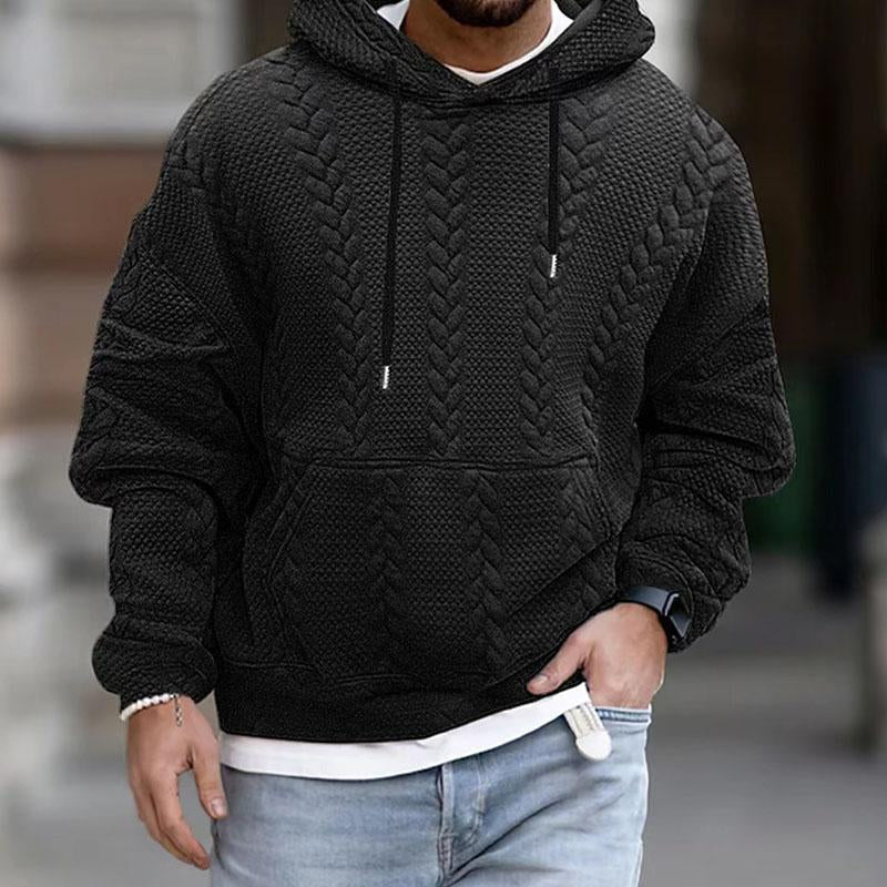 Black cable knit hoodie for men with a drop shoulder, relaxed fit, drawstring hood, and kangaroo pocket