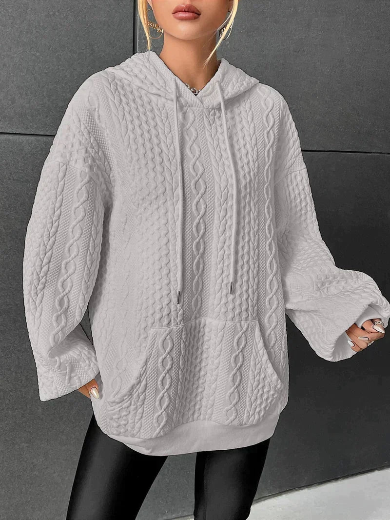 Gray oversized cable knit hoodie for women with a kangaroo pocket, drawstring hood, and long sleeves