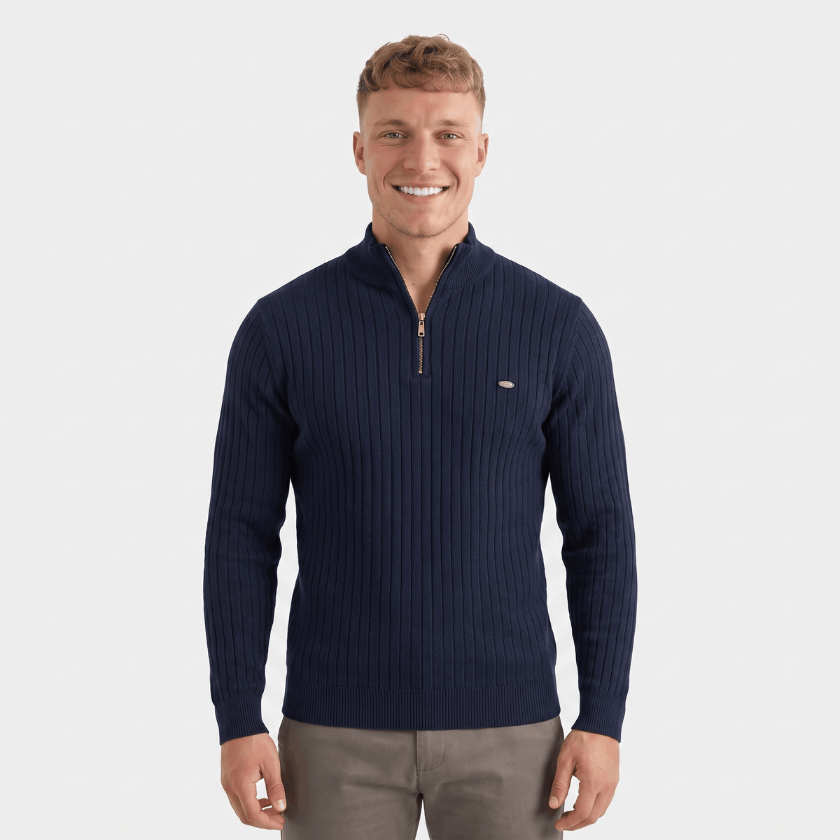 Man wearing a navy ribbed quarter-zip knit sweater featuring a stand collar, long sleeves, and a tailored fit.