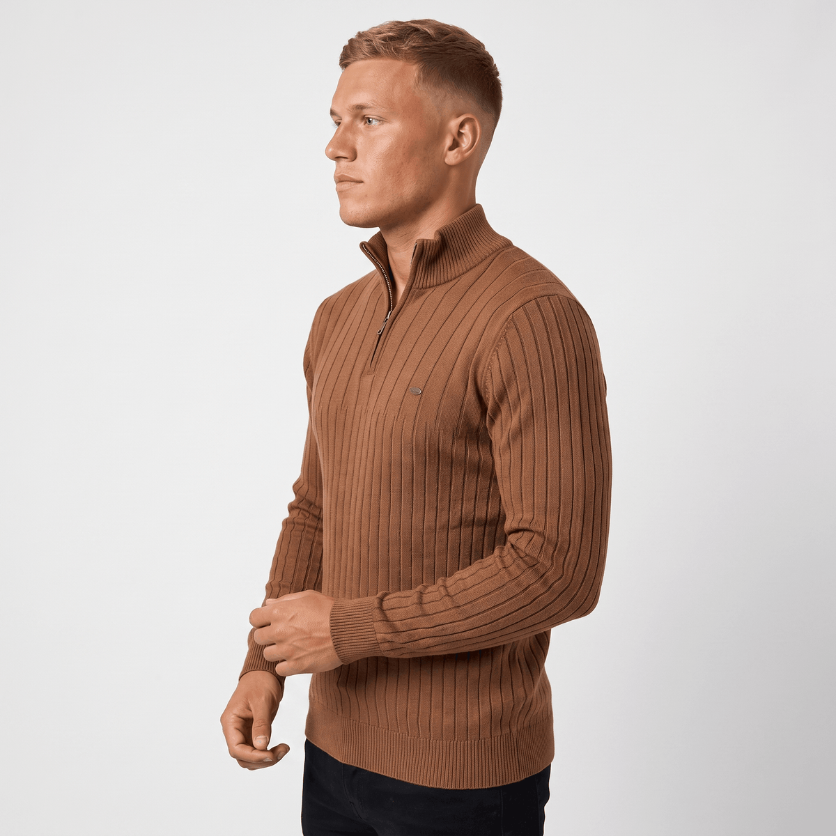 Side view of a man wearing a brown ribbed quarter-zip sweater with a stand collar and classic fit.
