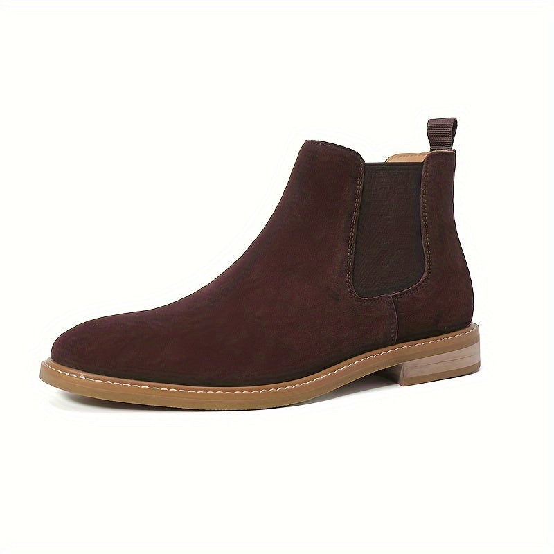 Side profile of a dark brown Chelsea ankle boot for men showing the pale contrast sole and low heel