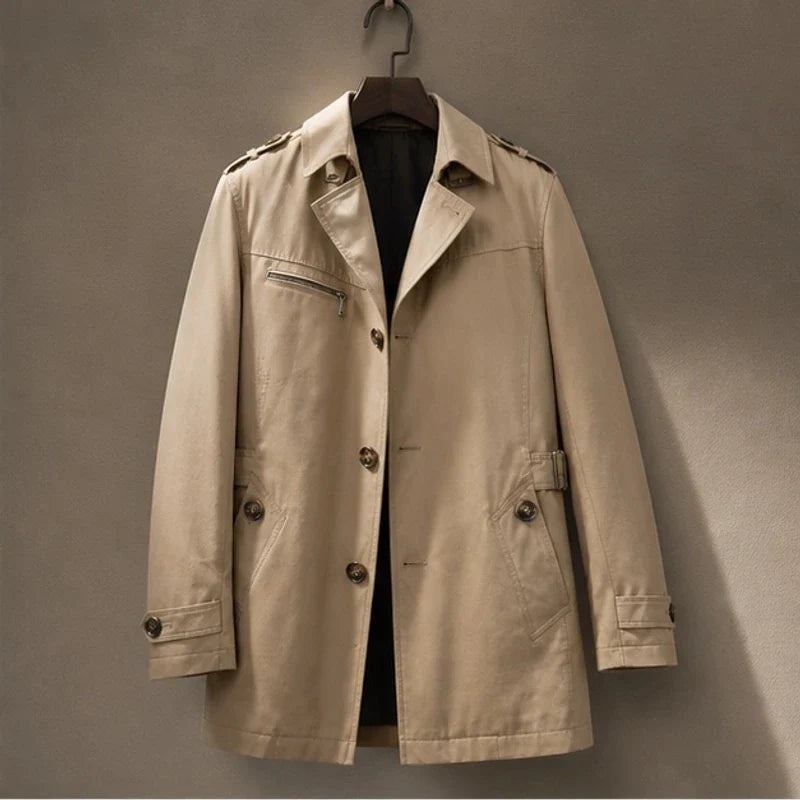A beige cotton blend trench coat with a belted waist and structured collar, shown flat