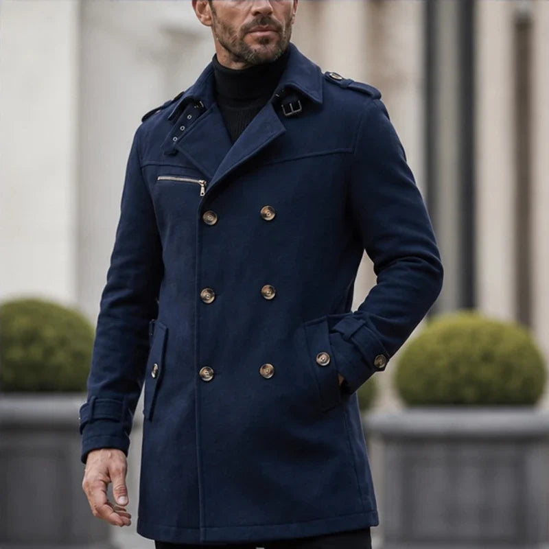 A man wearing a navy blue cotton blend trench coat with a belted waist and double-breasted front