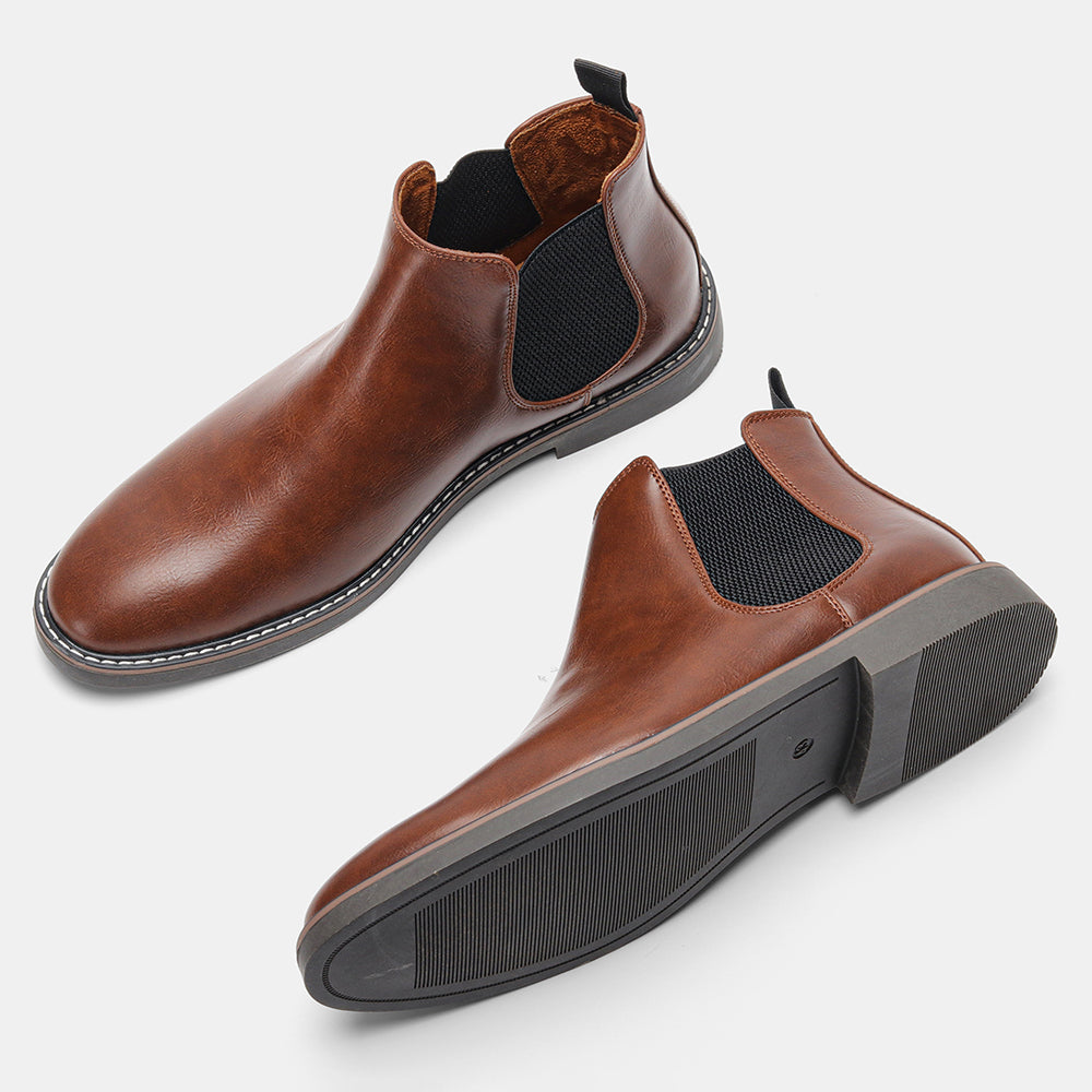 Distressed brown leather Chelsea boots with black elastic side panels, back pull loops, and a stitched welt sole.