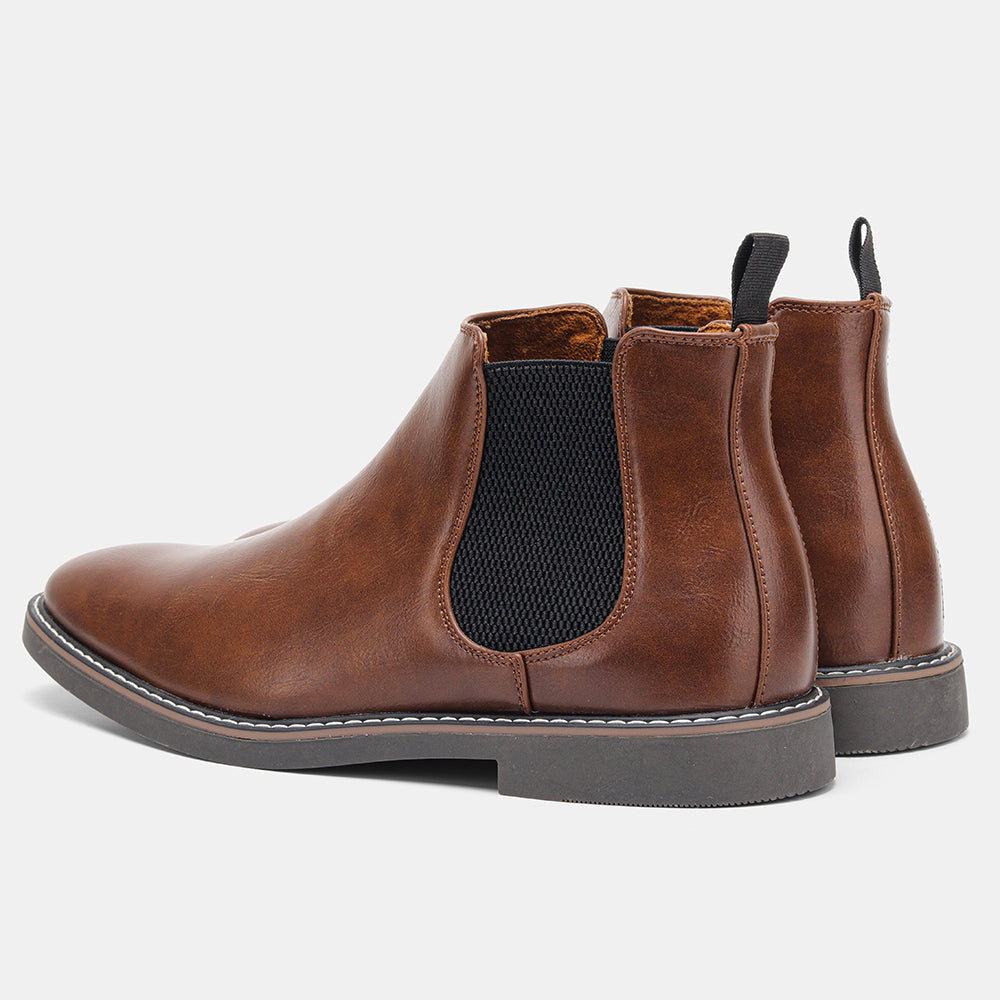 Distressed brown leather Chelsea boots with black elastic side panels, back pull loops, and a stitched welt sole.