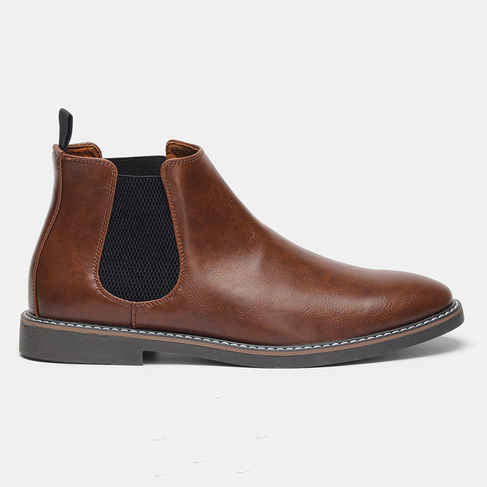 Distressed brown leather Chelsea boots with black elastic side panels, a back pull loop, and a stitched welt sole.