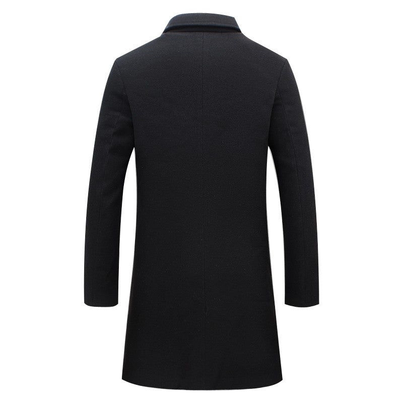 A black double-breasted winter trench coat with a tailored longline fit, shown from the back