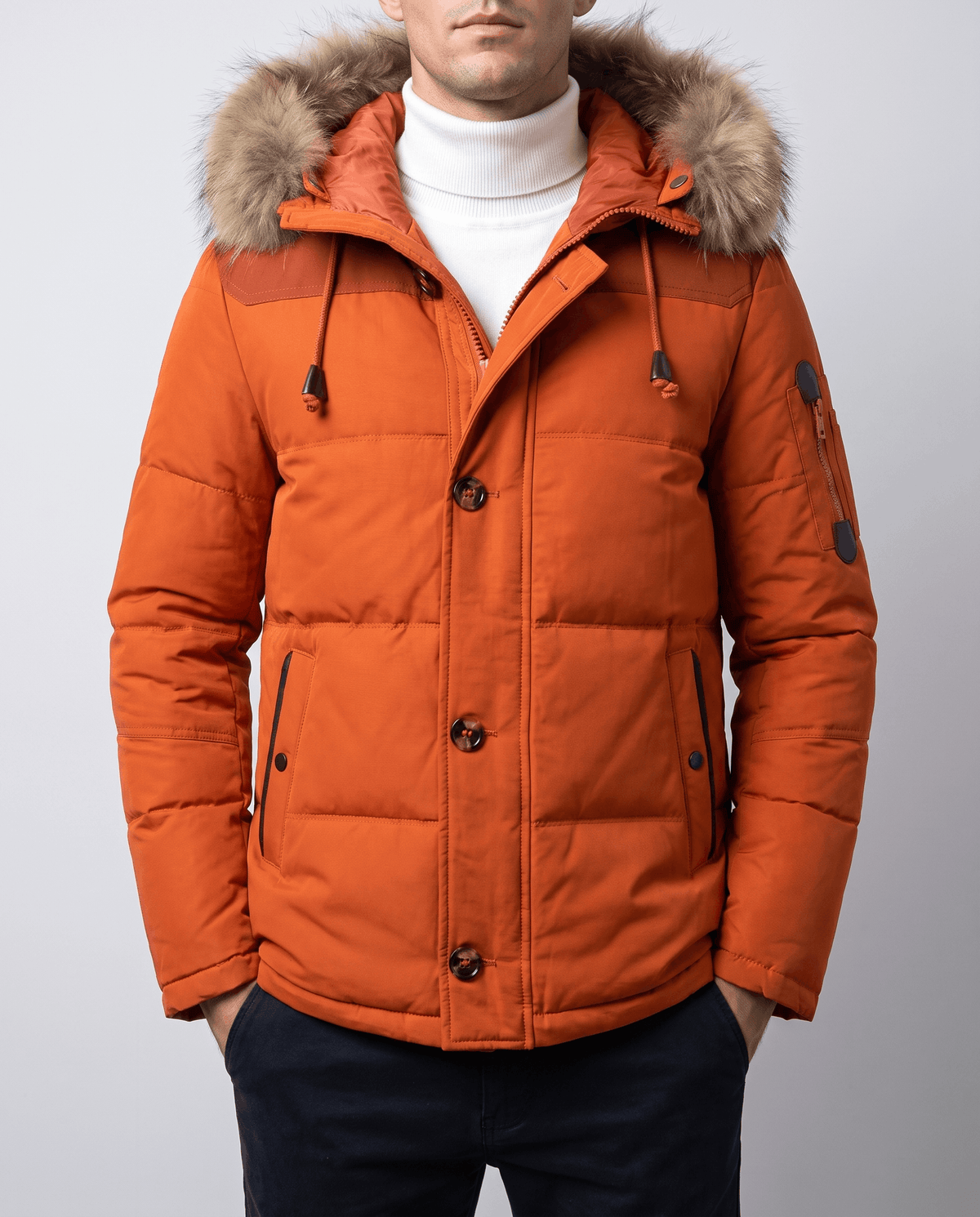 Orange duck down winter parka with plush-trim hood and zip pockets worn by a male model