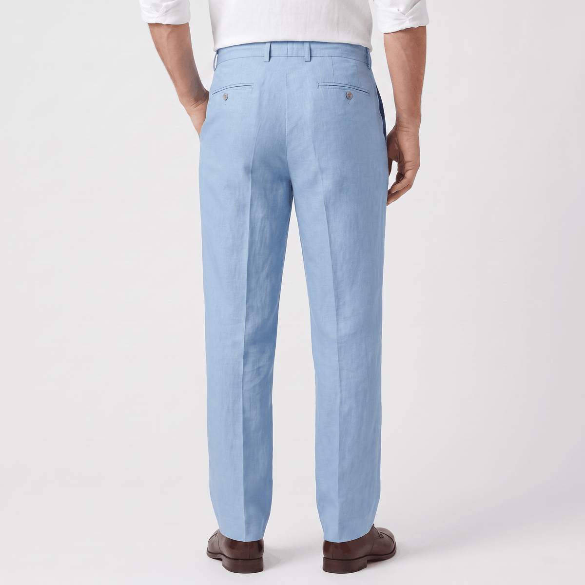 Back view of men's light blue linen drawstring pants with an elastic waistband and relaxed fit.