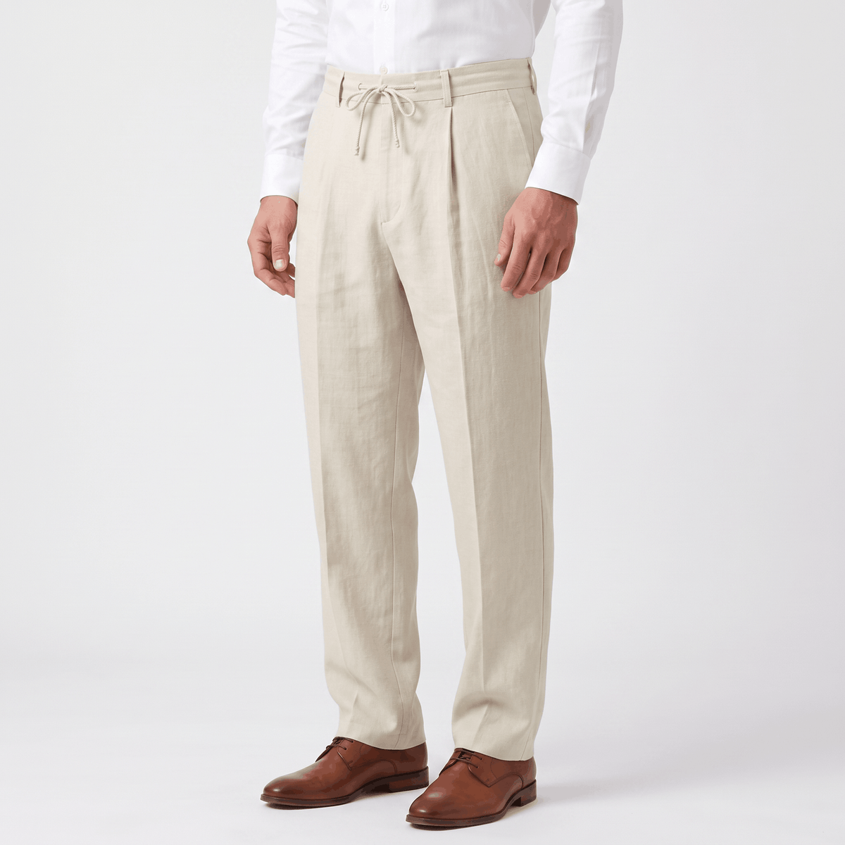Side view of men's cream linen drawstring pants featuring a lightweight linen construction and relaxed silhouette.