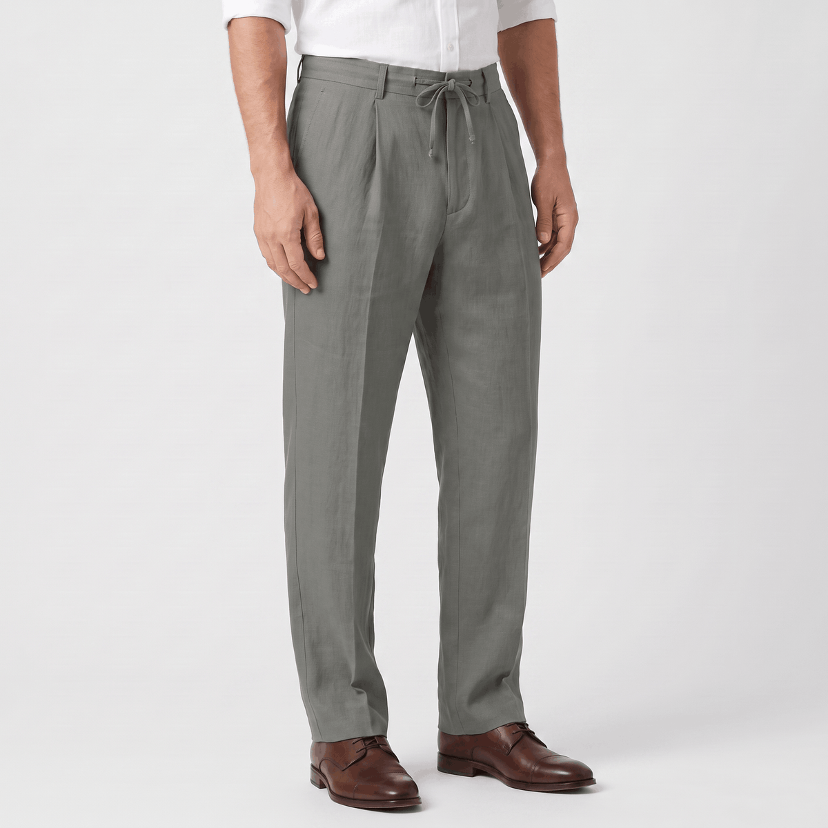 Side view of men's gray linen drawstring pants featuring a relaxed straight-leg silhouette, elastic waistband, and breathable linen fabric.