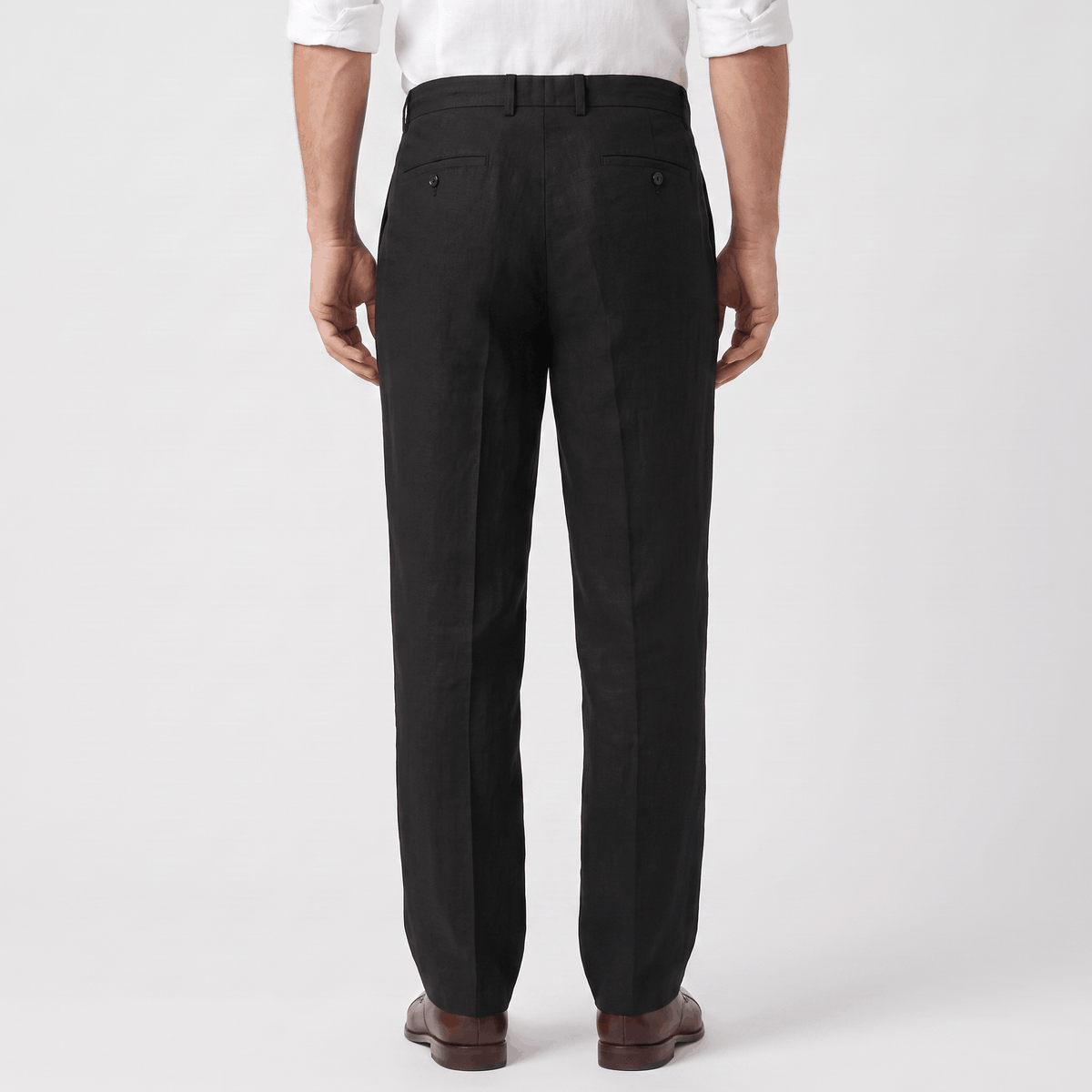 Back view of men's black linen drawstring pants with an elastic waistband and relaxed straight-leg fit.
