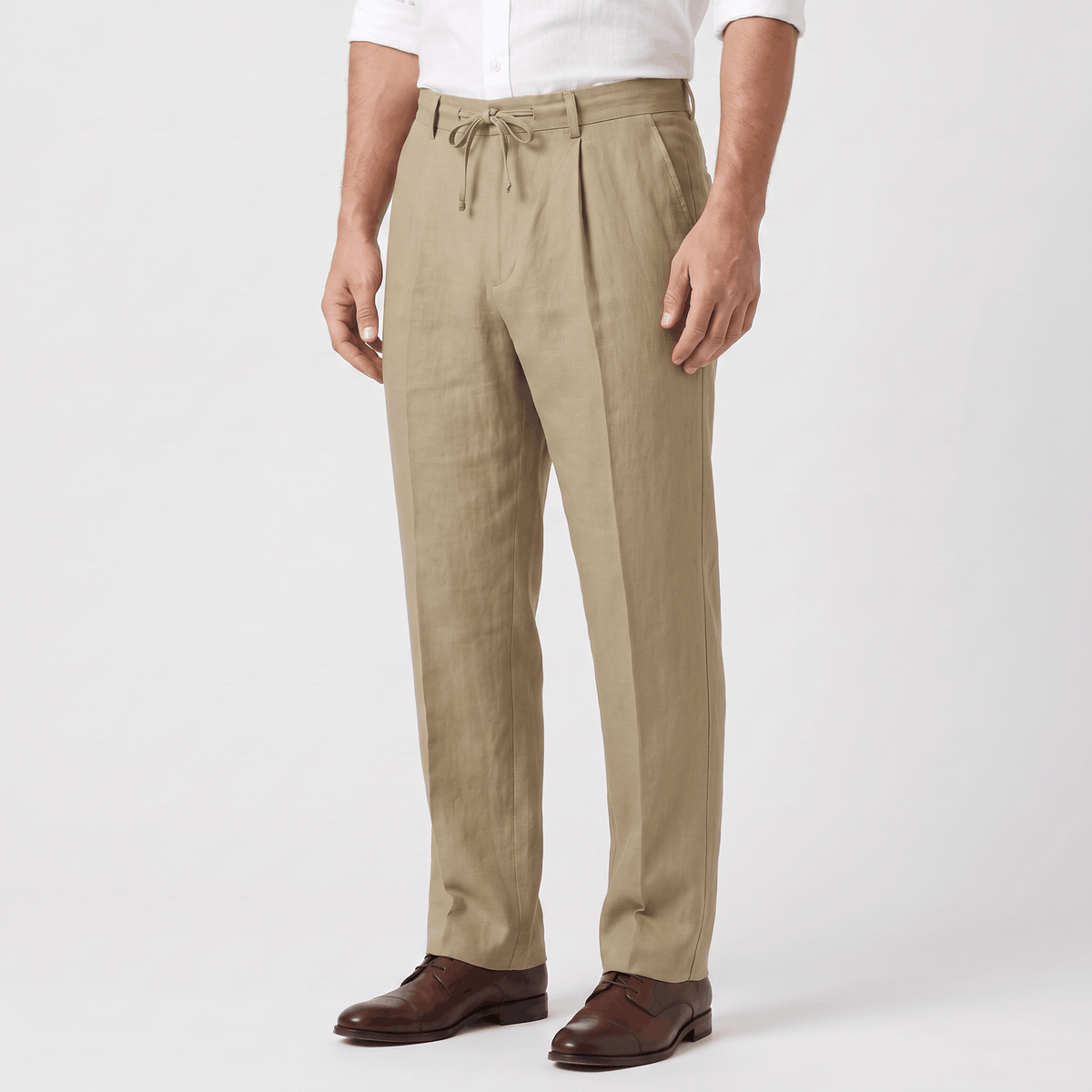 Side view of men's khaki linen drawstring pants featuring a relaxed silhouette and lightweight linen fabric.