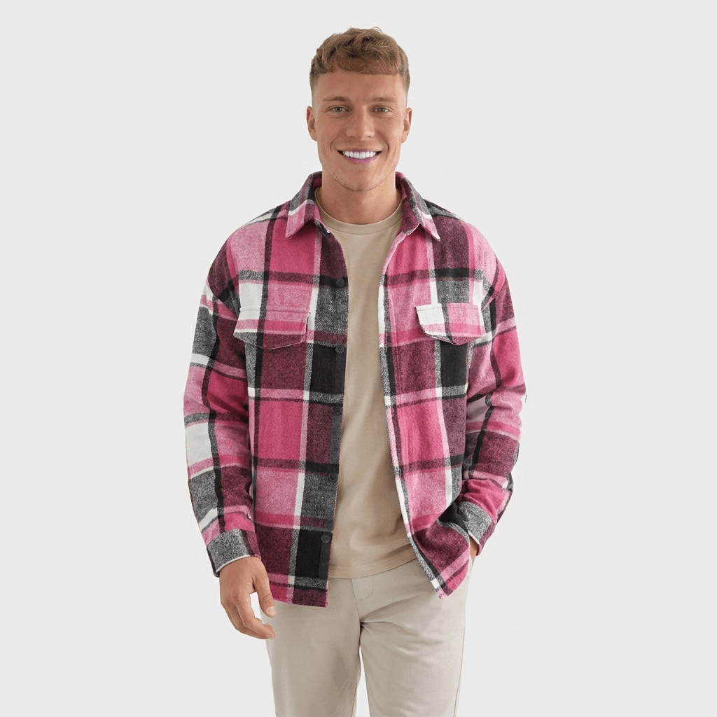 Man wearing a pink, burgundy, and white plaid overshirt jacket with a button-front closure, chest pockets, and long sleeves.