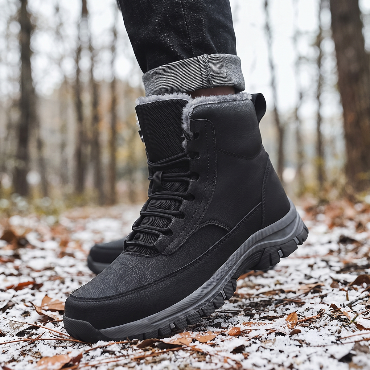 A person wearing black fleece-lined high-top winter boots with water-repellent uppers and lug soles outdoors