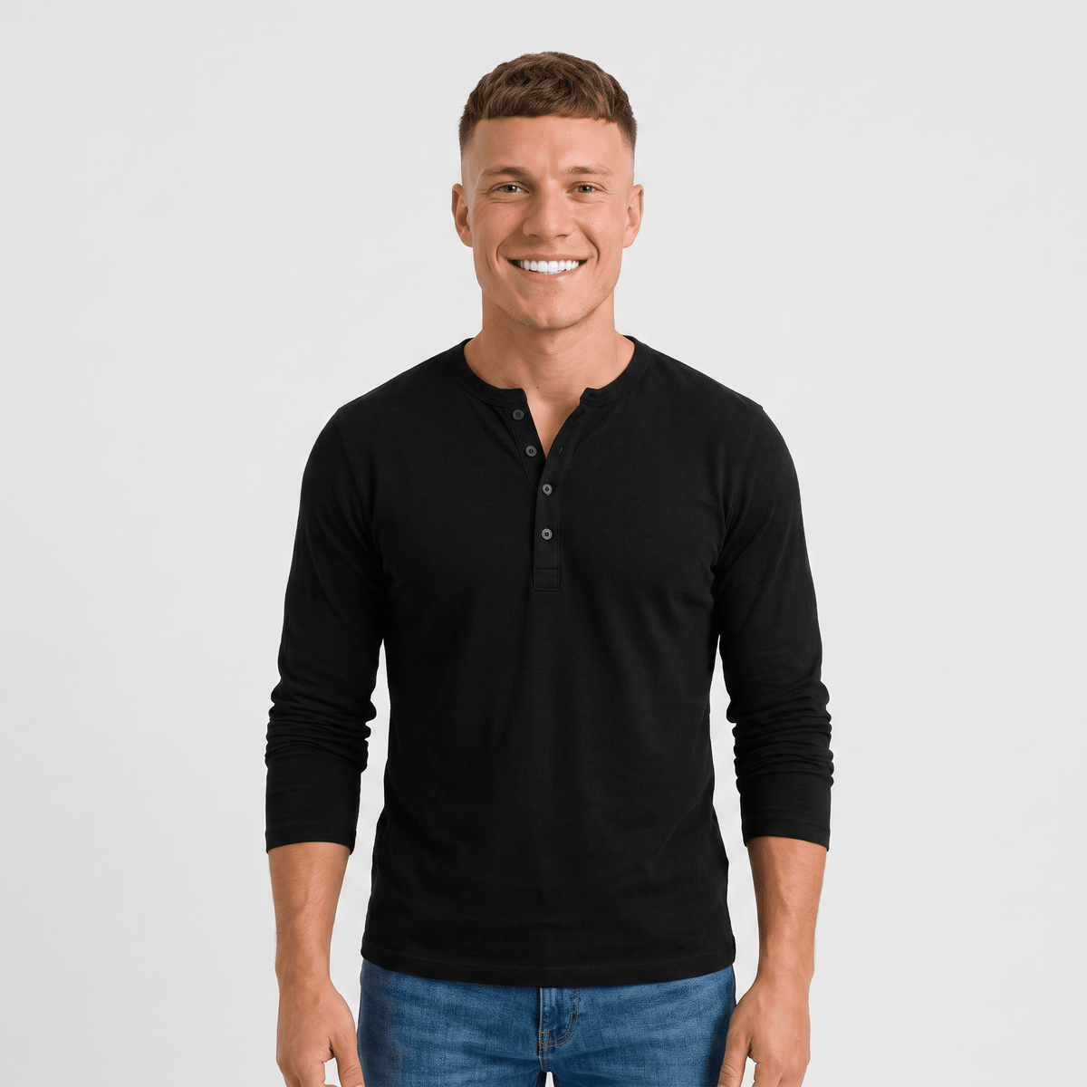 Man wearing a black long-sleeve Henley shirt with a three-button placket, crew neckline, and modern fit.