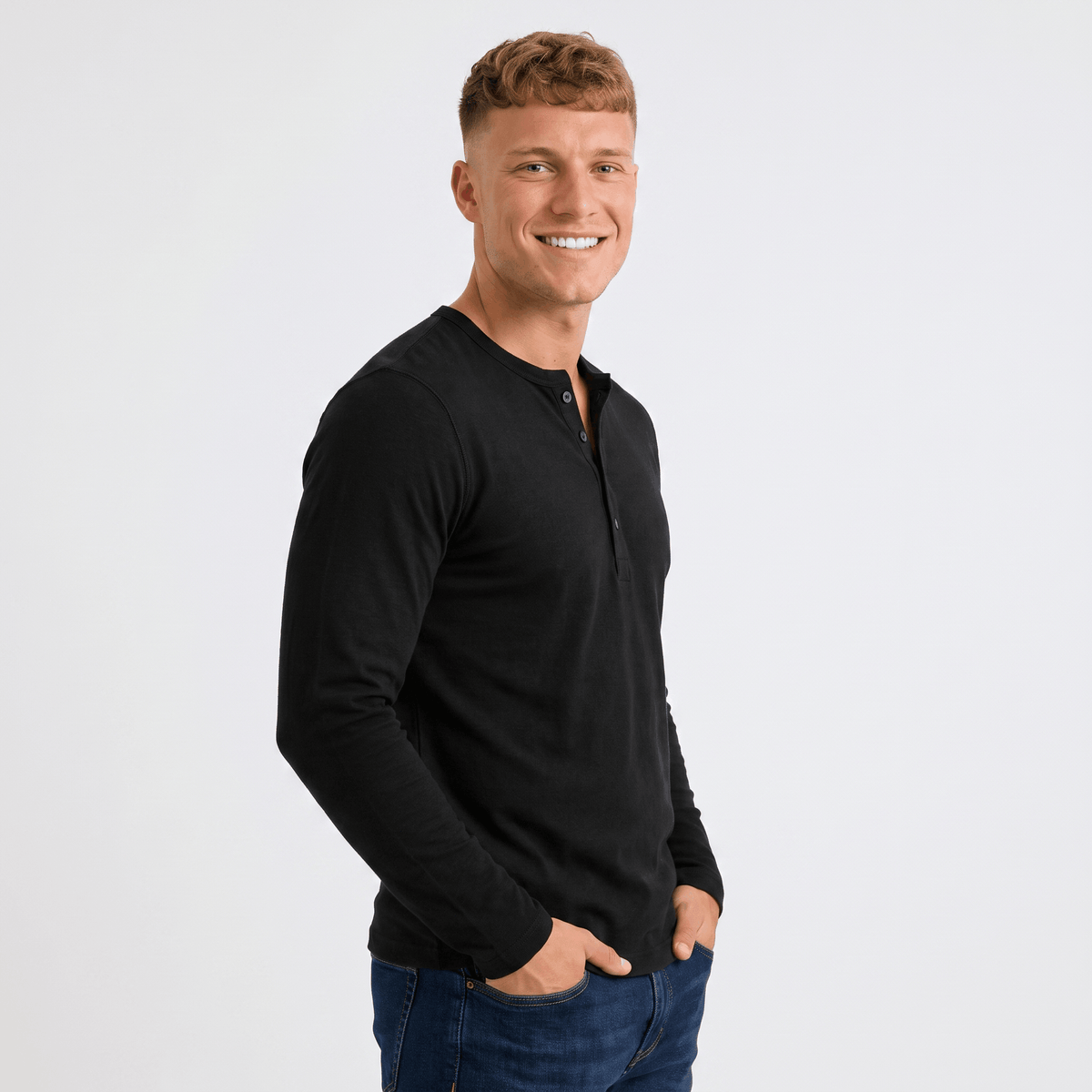 Side view of a man wearing a black long-sleeve Henley shirt with a three-button placket and slim fit.