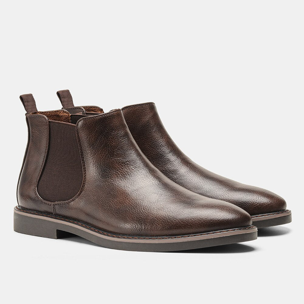 Pair of dark brown Chelsea boots with elastic side panels, pull tabs, smooth leather uppers, and low-profile soles.