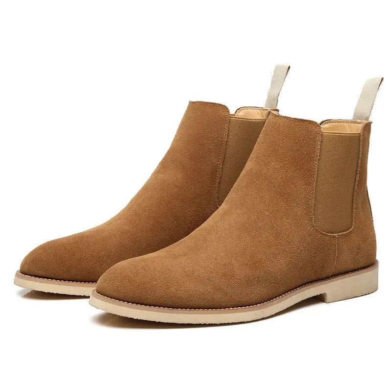 Pair of brown suede Chelsea boots displayed together, showing the elastic panels, pull tabs, and light-colored soles.