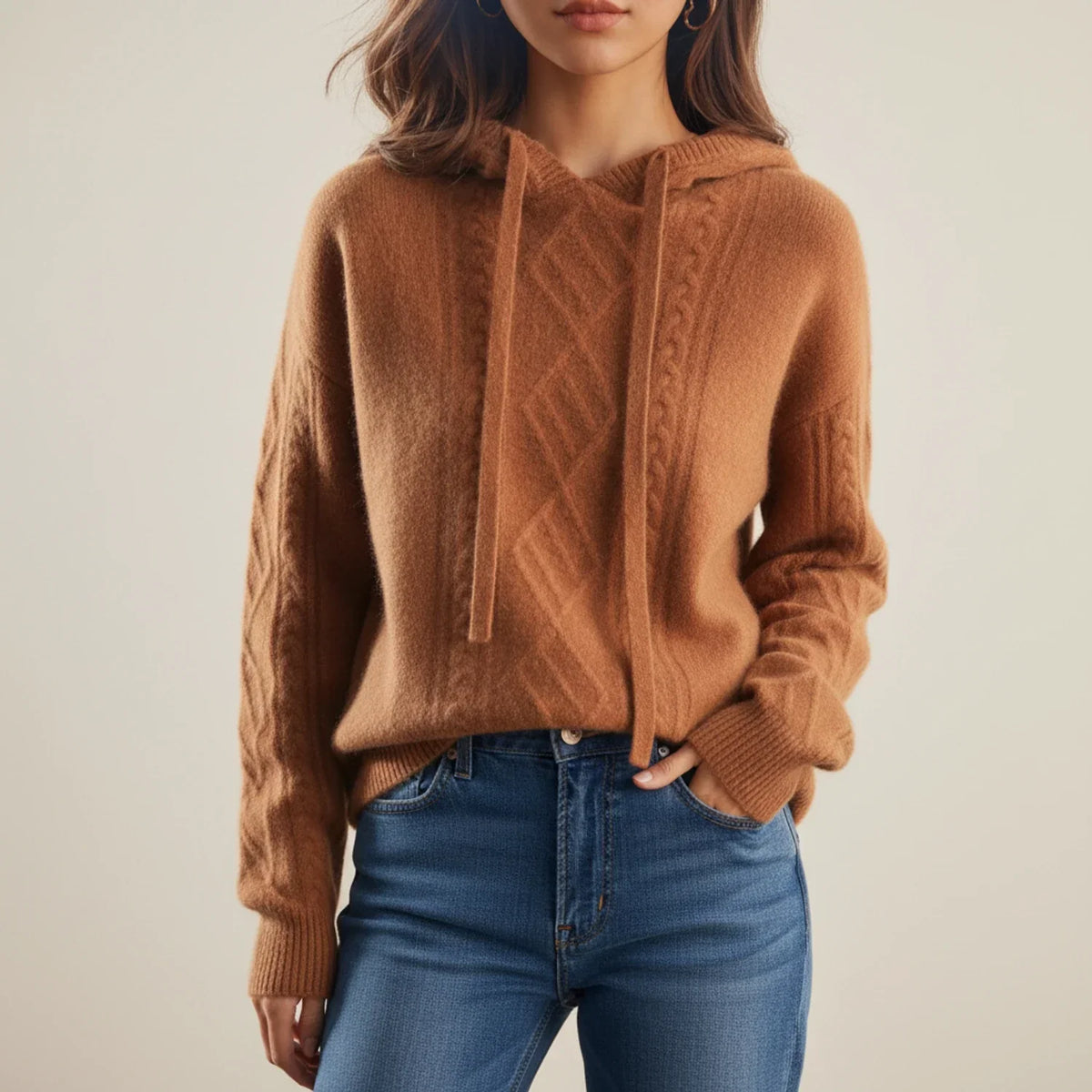 Brown hooded cable knit sweater with long sleeves, textured cable knit pattern, and ribbed cuffs and hem