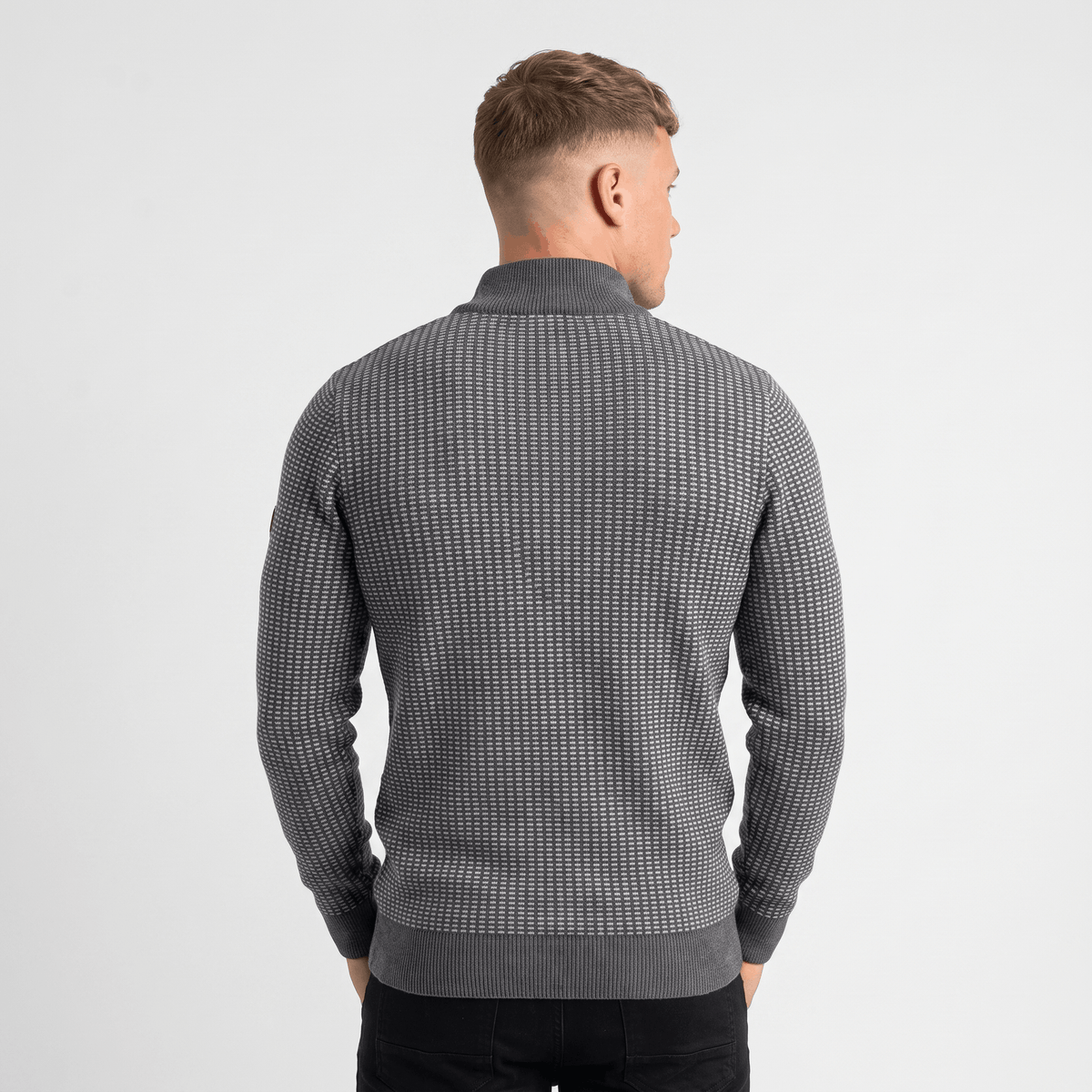 Back view of a men's gray textured quarter-zip knit sweater with a stand collar and all-over textured pattern.