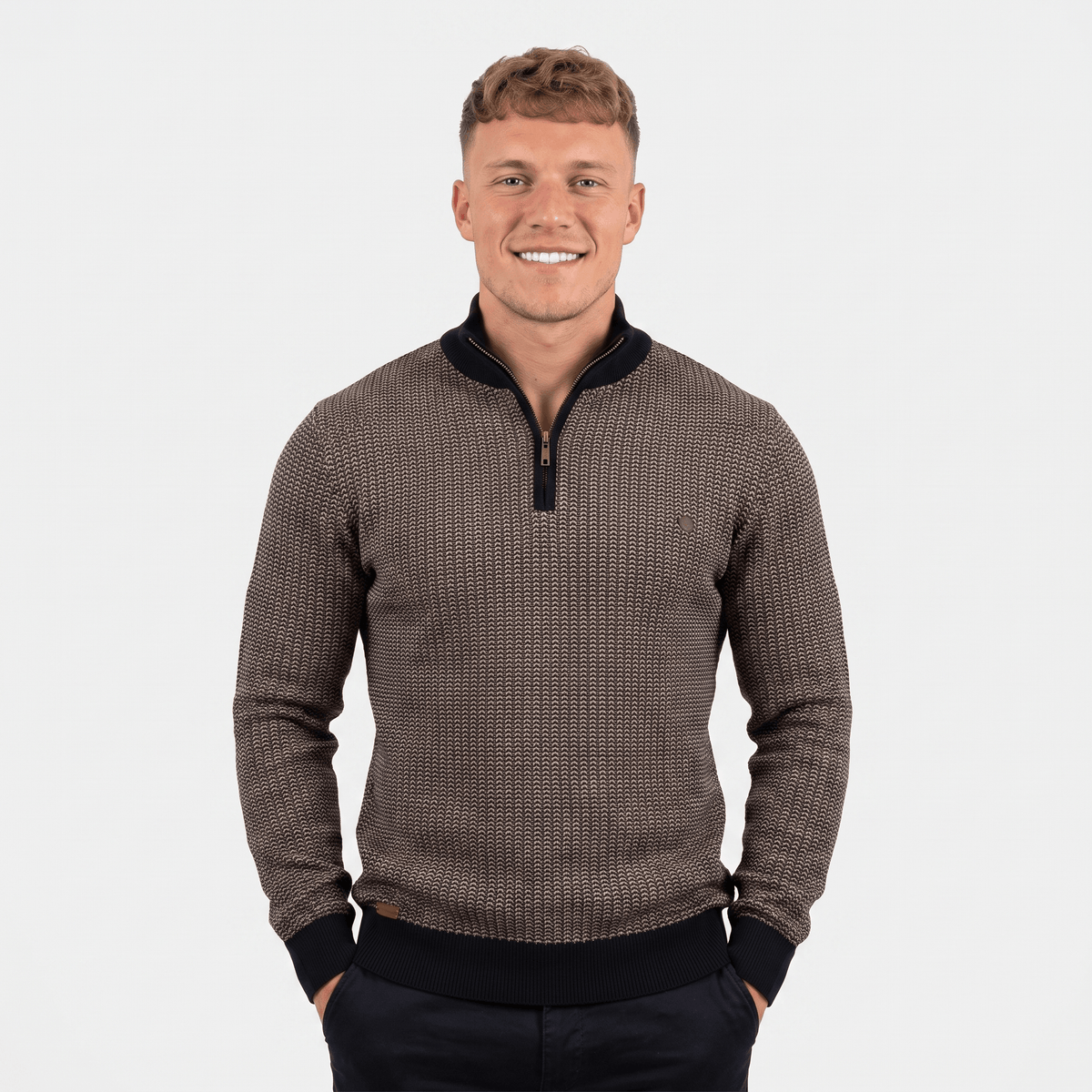 Man wearing a brown textured quarter-zip knit sweater with a stand collar, long sleeves, and a modern slim fit.