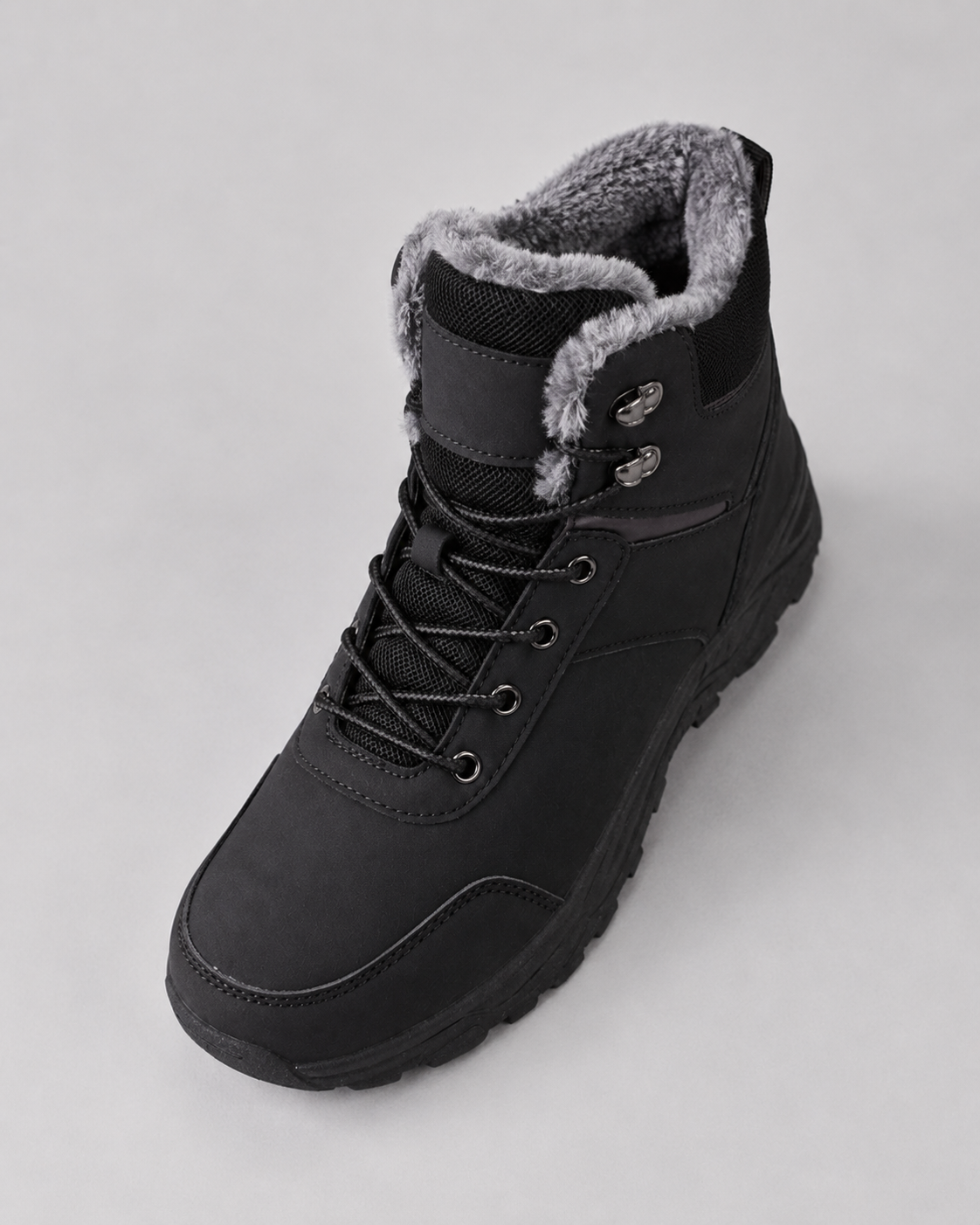 Black lace-up winter ankle boot with a plush-lined collar and lug sole, side view