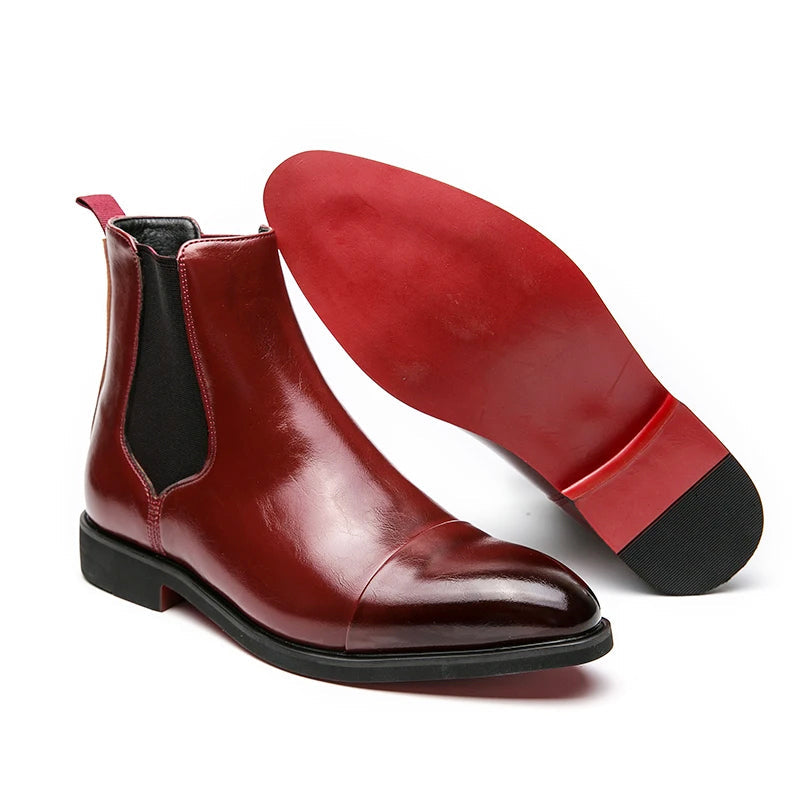 Pair of burgundy red leather Chelsea boots with elastic side panels, pointed toes, and low block heels.
