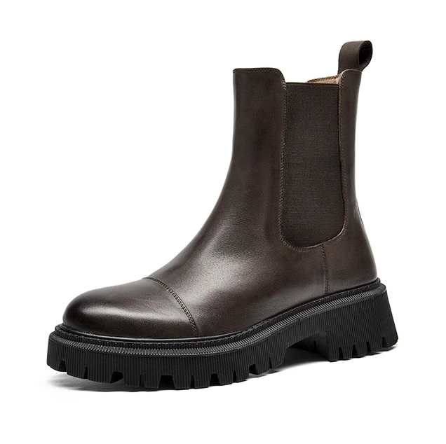 Side profile of a dark brown leather Chelsea ankle boot for women with cap-toe seam and lug sole