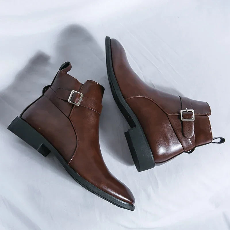 Single dark brown leather ankle boot with a side buckle, pointed toe, pull tab, and block heel.