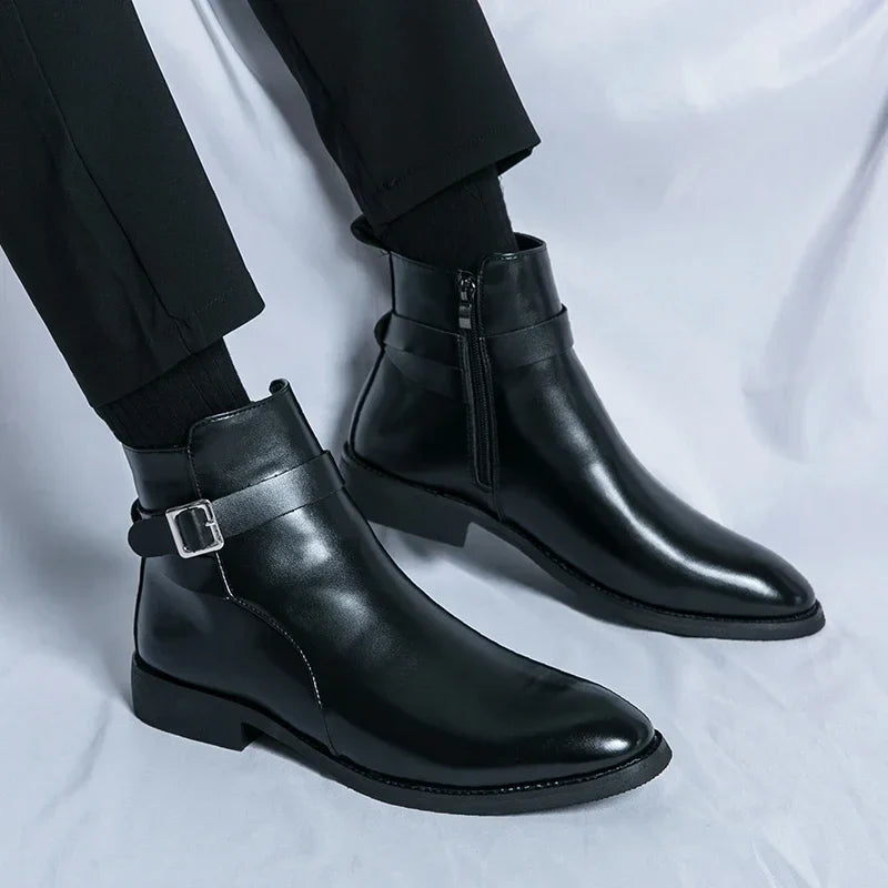 Person wearing black leather ankle boots with side buckles, pointed toes, and block heels.