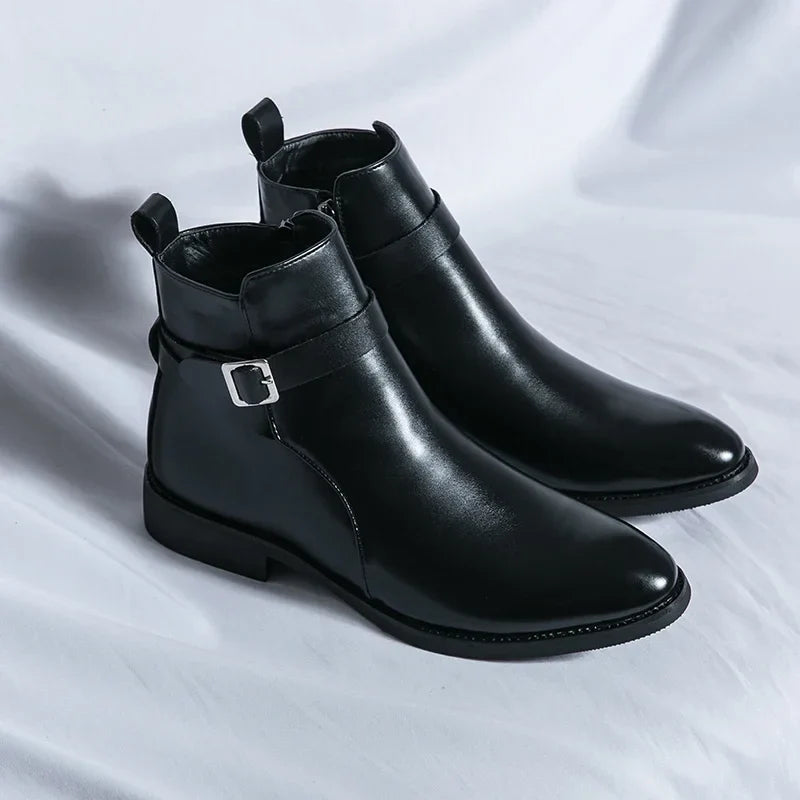 Pair of black leather ankle boots displayed together, featuring side buckles, pull tabs, pointed toes, and block heels.