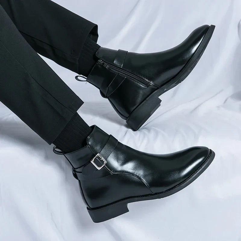 Person wearing black leather ankle boots with buckled straps, showing the side profile and block heels.