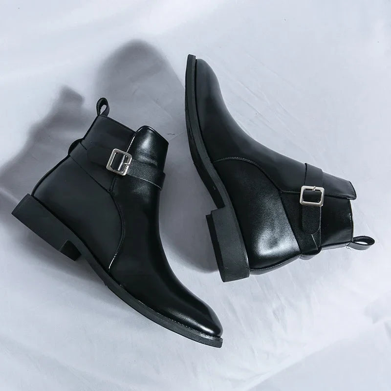 Pair of black leather ankle boots displayed together, showing the side buckles, pointed toes, and block heels.