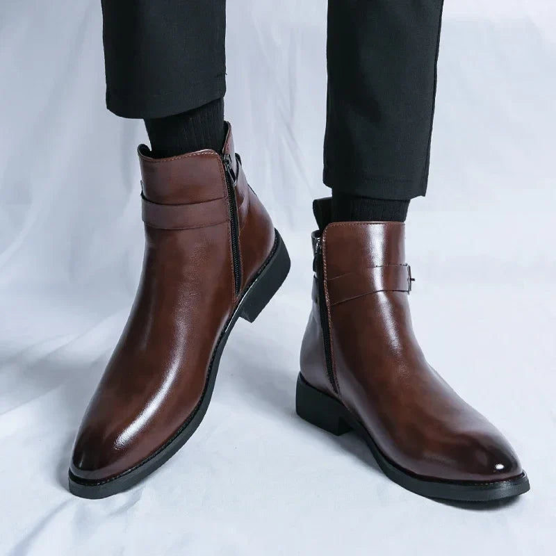 Person wearing dark brown leather ankle boots, showing the side profile, pointed toes, and block heels.