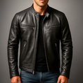 A person wearing a black leather moto jacket with a zip front, stand collar, and zippered pockets