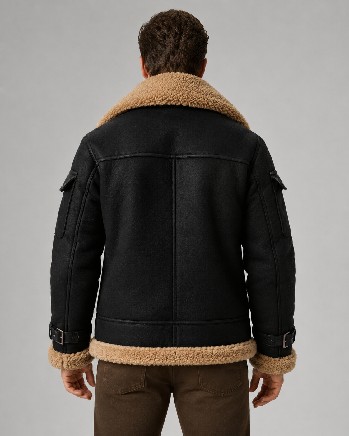 Black leather shearling aviator jacket for men worn by a male model, back view with thick shell and plush collar