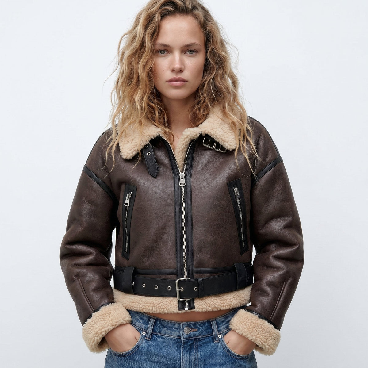 Dark Brown leather shearling bomber jacket for women with cropped fit, shearling trim, belt detail, and zip pockets