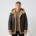 A man wearing a dark brown leather shearling jacket with a hood, plush lining, and button closure