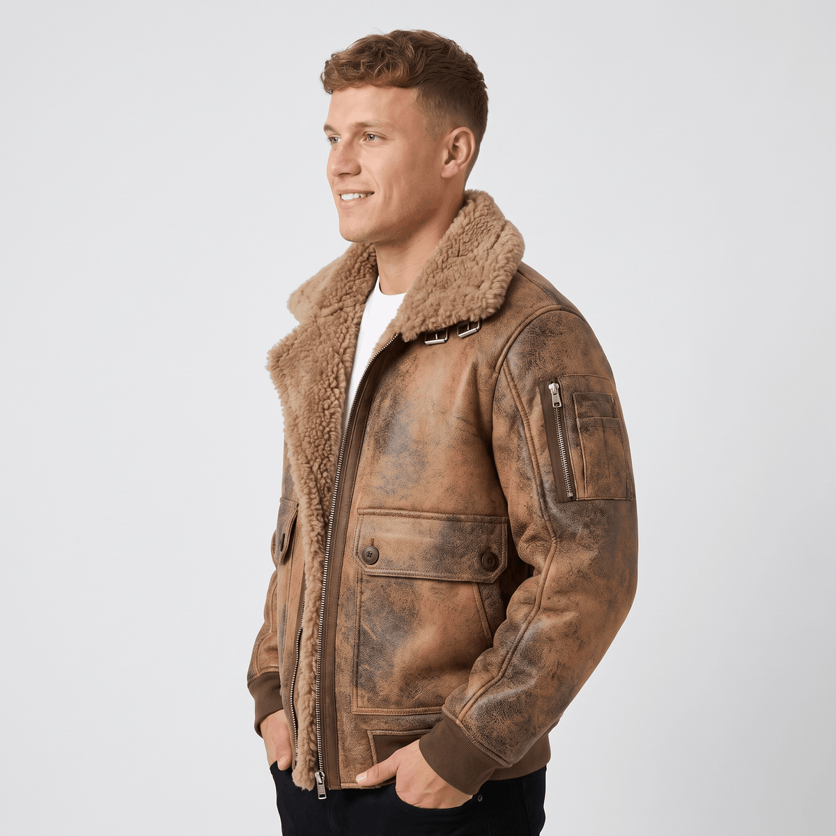 A man wearing a brown leather shearling jacket with plush lining, a full-zip front, and a shearling collar, side view
